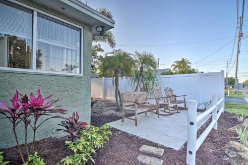 a patio with a table and chairs next to a house at Vibrant Dunedin Getaway with Furnished Patio! in Dunedin
