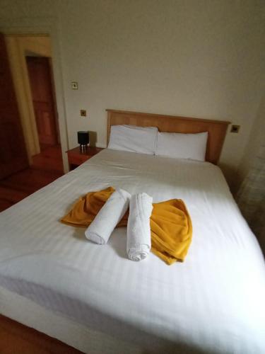 a bedroom with a bed with two towels on it at Clós Na Feirme in Galway