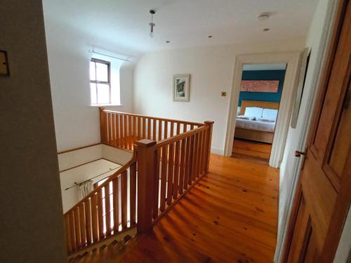 a room with a staircase and a bedroom with a bed at Clós Na Feirme in Galway