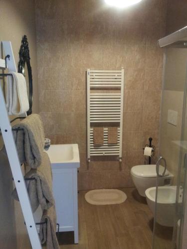 a bathroom with a sink and a toilet and a window at Dear Venice Bed & Breakfast in Marghera