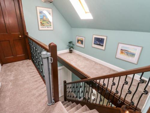 a staircase in a home with blue walls at Ulla Dhu in Nethy Bridge