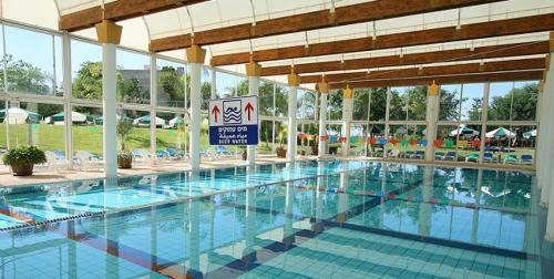 a large swimming pool in a large building at Ayelet Aviv in Caesarea