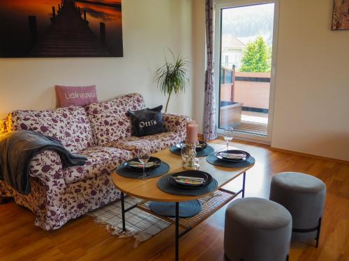 a living room with a couch and a table at Ottl's Appartements mit Kreischbergblick in Sankt Lorenzen ob Murau