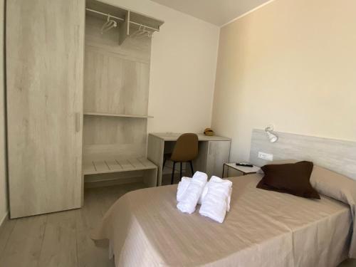 a bedroom with a bed with towels on it at Villa Lentischio in Budoni