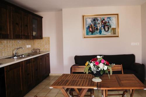 a kitchen with a table with a vase of flowers on it at Le Antiche Colonne in Cinquefrondi