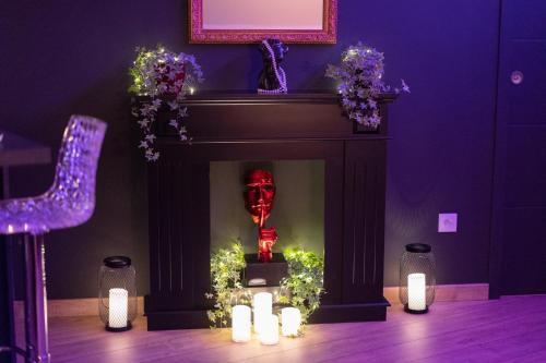 a fireplace with christmas lights in a room at L'écrin des secrets in Villeperdue