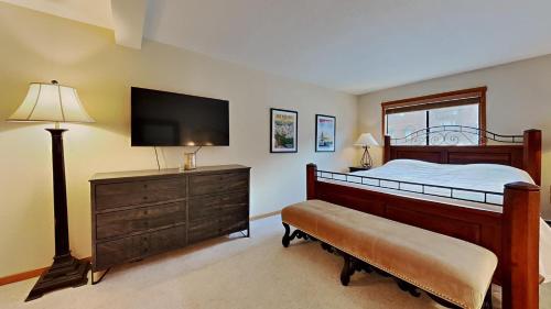 a bedroom with a bed with a television and a dresser at Spacious One Bedroom Condo in Mammoth! Free Assigned Parking - Snowbird 107 in Mammoth Lakes