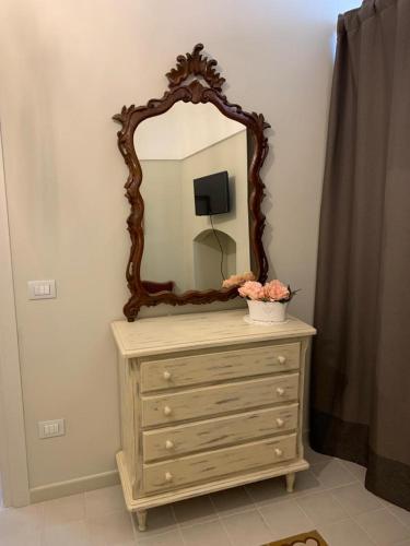 a dresser with a mirror on top of it at Dimora del Castellano CASA SATURNO in Gioia del Colle