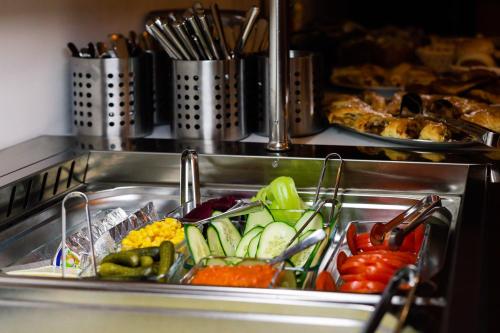 a bunch of vegetables in a sink in a kitchen at Grand Lakes 2 in Plitvička Jezera