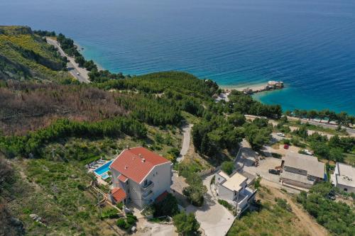 an aerial view of a house on a hill next to the ocean at Luxury Apartments Tafra in Lokva Rogoznica