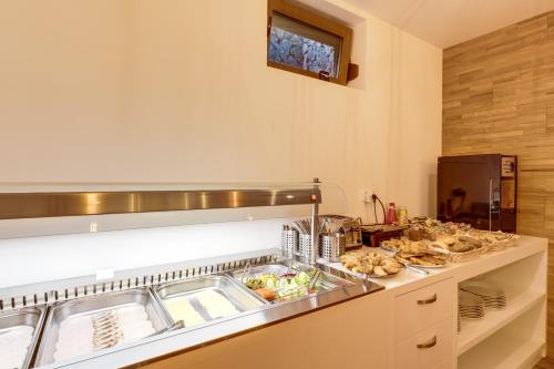 a kitchen with a counter with some food on it at Grand Lakes 2 in Plitvička Jezera