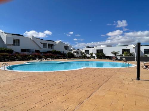 a swimming pool in front of some houses at Suite Dreams Fuerteventura in Villaverde
