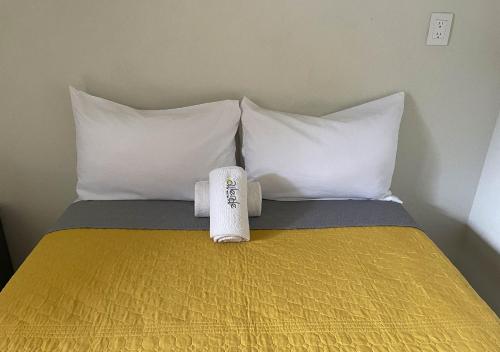 a hotel room with a bed with two towels on it at Hotel Allende Morelia in Morelia