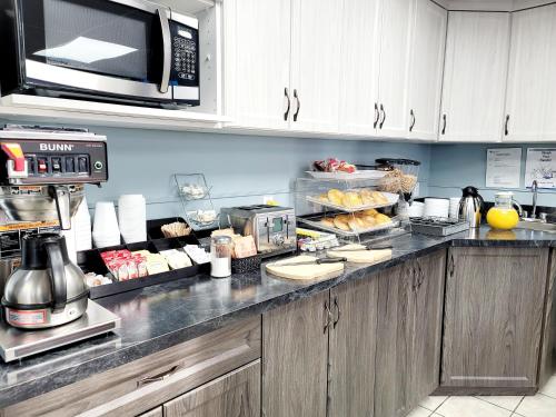 a kitchen with a counter with some food on it at Canadian Motor Inn in Grande Prairie