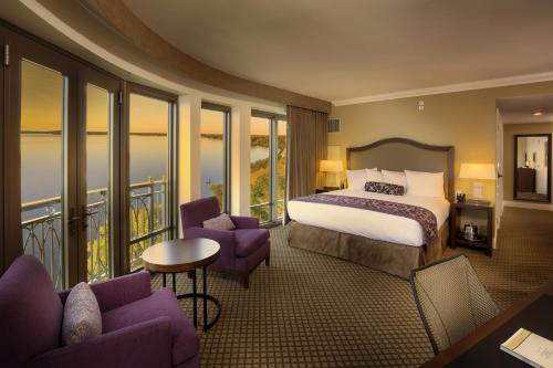 a hotel room with a bed and a balcony at The Edgewater in Madison