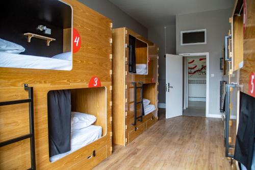 a room with two bunk beds and a hallway at Leevin Hostel Mountjoy in Dublin
