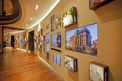 a hallway of a building with pictures on the wall at The Edgewater in Madison