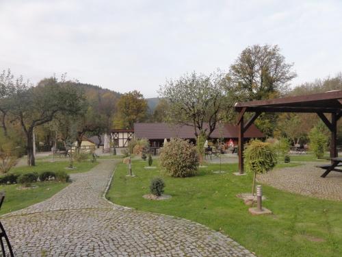 a garden with a stone path and a pavilion at Chata nad Sztolnią in Bystrzyca Górna
