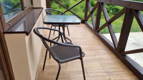 two chairs and a table on a balcony at SPA Resort Villa Sofia in Yablunytsya