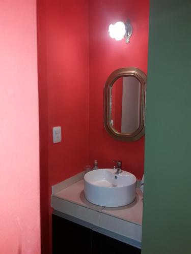 a bathroom with a white sink and a mirror at Abuela Chela in Villa Carlos Paz