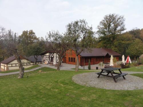 a park with a picnic table in front of a building at Chata nad Sztolnią in Bystrzyca Górna