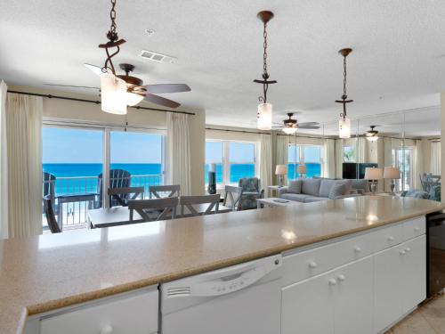 a kitchen and living room with a view of the ocean at Emerald Dunes 301 by Newman-Dailey in Destin