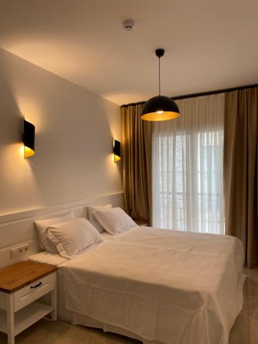 A bed or beds in a room at Amber Boutique Hotel