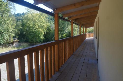 a covered deck with a view of the woods at TARNICA in Dwernik