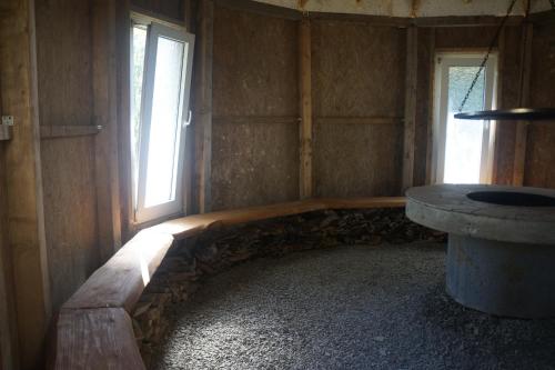 una stanza vuota con una panca in pietra e una finestra di TARNICA a Dwernik