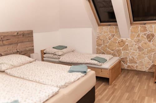 a room with two beds and a tv on the wall at GRANÁRIUM in Jablonov nad Turnou
