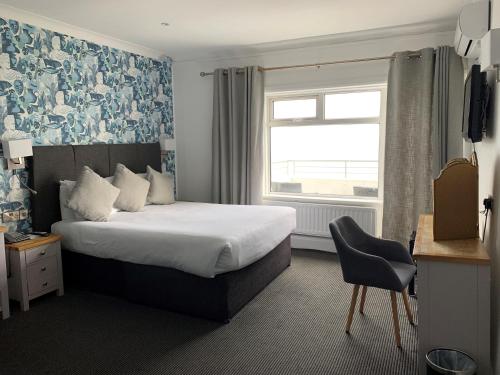 a hotel room with a bed and a window at Cumberland Hotel - OCEANA COLLECTION in Bournemouth