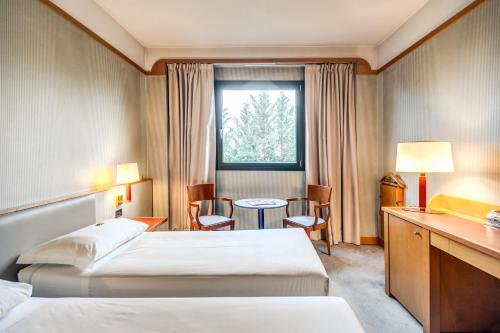 Säng eller sängar i ett rum på Hotel Della Rotonda
