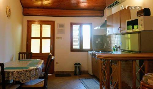a kitchen with a table and a counter top at Family*** in Selce