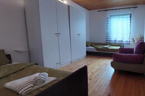 a room with a bed and a couch and a bedroom at Villa Ramonda in Dolna Matka