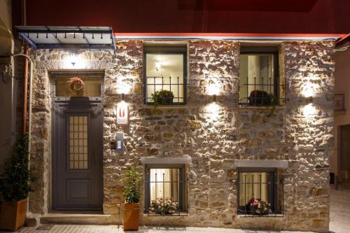 a stone building with windows and a door at ΟNIRO Comfort Living in Ioannina