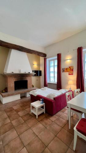 a bedroom with a large bed and a fireplace at Suites Mansion in Rozzano