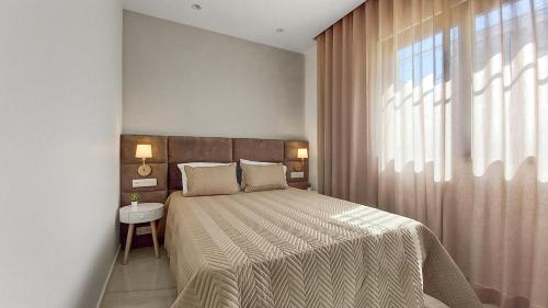 a bedroom with a large bed and a window at Seven Seas Apartments in Nazaré