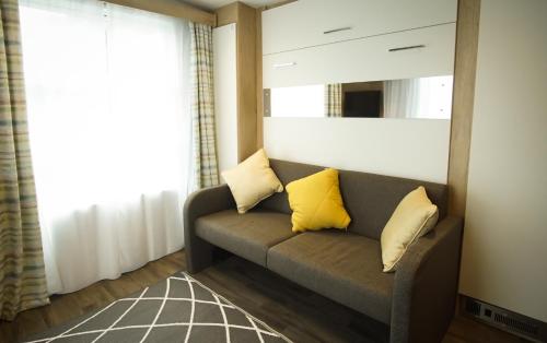 a living room with a couch and a mirror at Benvoulin Bothy - luxury pod with stunning views in Oban