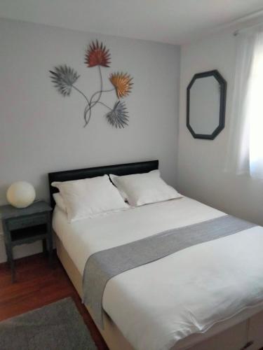 a bedroom with a bed and a mirror on the wall at beautiful apartment with garden in Amélie-les-Bains-Palalda