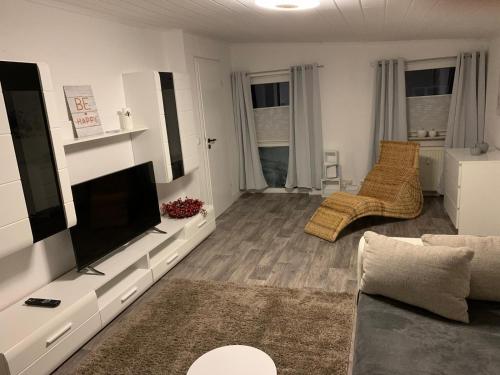 a living room with a flat screen tv and a couch at Wohnung am Wasserturm in Ilsede