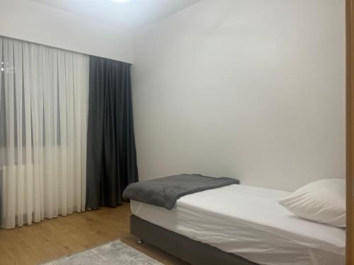 a bedroom with a bed and a window with curtains at Luxury privet 3 bed room 1 saloon security Nearby vadi istanbul 10min to mall of Istanbul and city centre private spa & winter pool for women in Istanbul