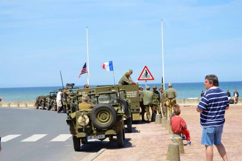 a group of military vehicles parked on the beach at Maison de charme à Saint-Laurent-sur-Mer, vue sur mer et jardin in Saint-Laurent-sur-Mer