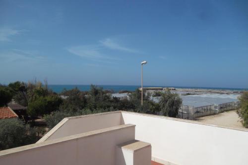 a view from the top of a white wall with a street light at Capo Scalambri in Santa Croce Camerina