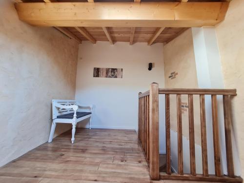 a stairway with a blue chair in a room at Triplex avec vue sur place du centre historique. in Foix