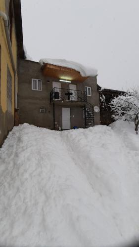 a pile of snow in front of a building at LeriMari in Mestia