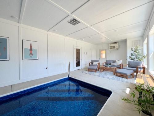 a swimming pool in a room with a living room at Sweet Tea Timber Indoor Pool Hot Tub in Pigeon Forge