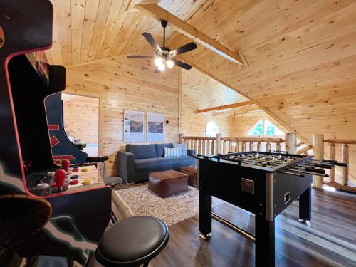 a living room with a ping pong table in a cabin at Sweet Tea Timber Indoor Pool Hot Tub in Pigeon Forge