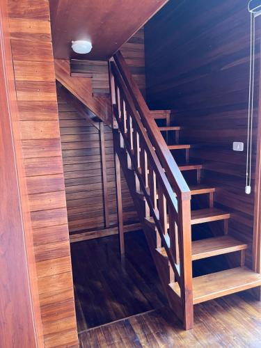 a wooden staircase in a room with wood floors at Mi Margarita Chalets in Alausí