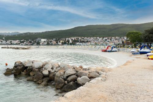 a beach with a bunch of rocks in the water at MOBILE HOMES SELCE - Lighthouse in Selce