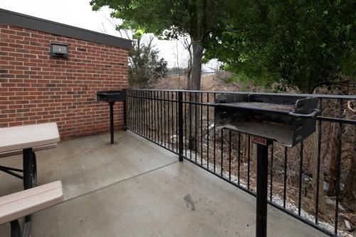 a barbecue grill on a fence on a patio at Red Roof Inn High Point - University in Westwood